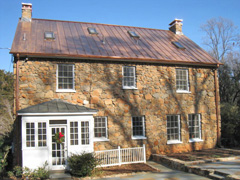 Beautiful stone house with a new copper roof and copper chimney caps just in time for Christmas!